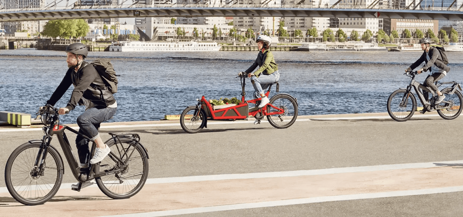 Cyclists riding KAMEO Bikes electric bikes in the city